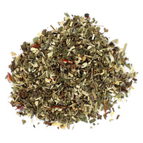 A pile of dried loose leaf tea with visible pieces of cranberry and herbs.