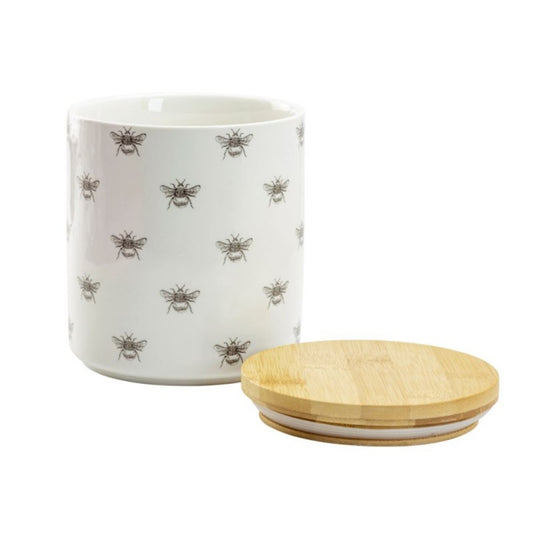 White container with bee pattern and wooden lid on a white background