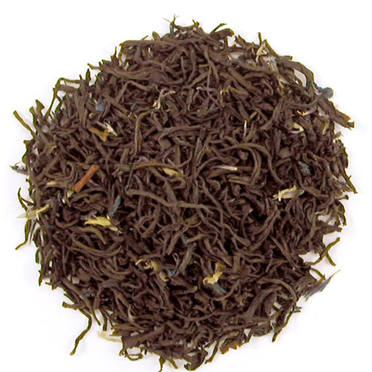 Close up of dry brown colored tea leaves in a circular pattern on a white background.
