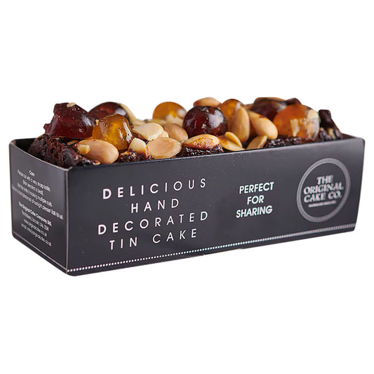 The Original Cake Co.'s Jewel Topped Rich Fruit Cake in a dark grey open box with white text on packaging all on a white background.