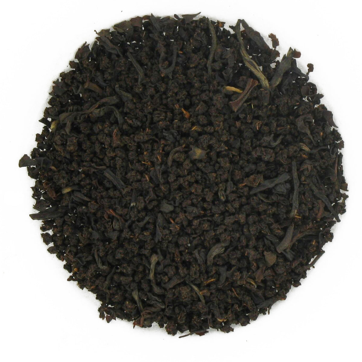 Close-up of black tea leaves on a white background