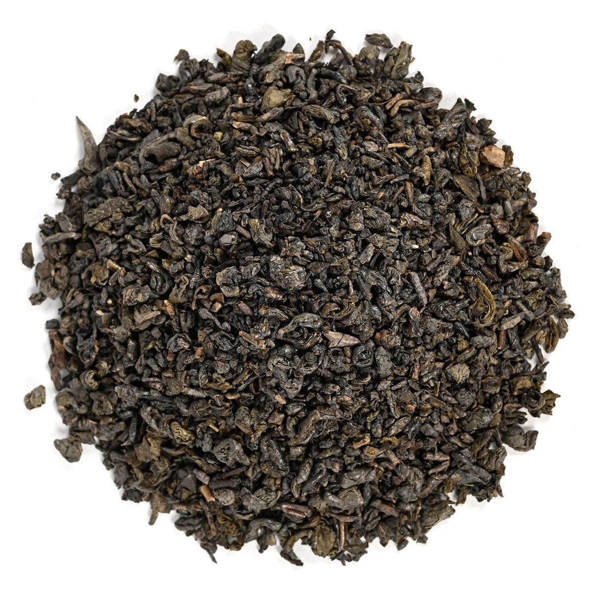 Pile of dark loose-leaf green tea leaves on a white background