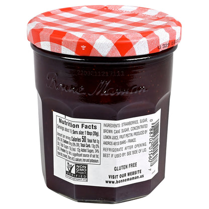 Jar of Bonne Maman strawberry jam with a red and white checkered lid on a white background