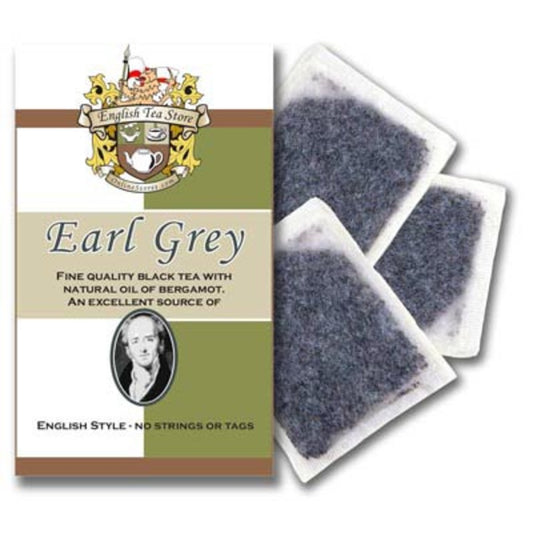 Package of tea with white and green coloring and the English Tea Store brand logo and crest with a description of Earl Grey tea and three tea bags on the side with visible tea leaves.
