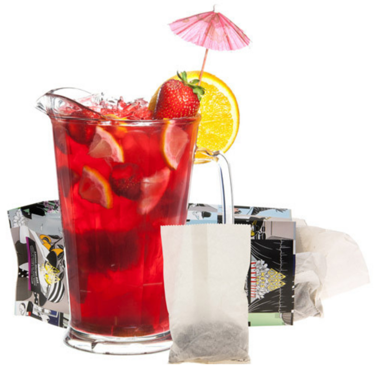 Red iced tea in a clear pitcher with fruit and a pink umbrella, tea bags, and a teabag packaging on a white background