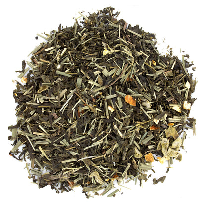 A pile of loose leaf tea with visible green tea leaves, pieces of lemongrass, and dried citrus fruit.
