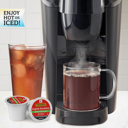 Black Keurig machine with a mug of hot black tea and a glass of iced tea, featuring Twinings tea packages.