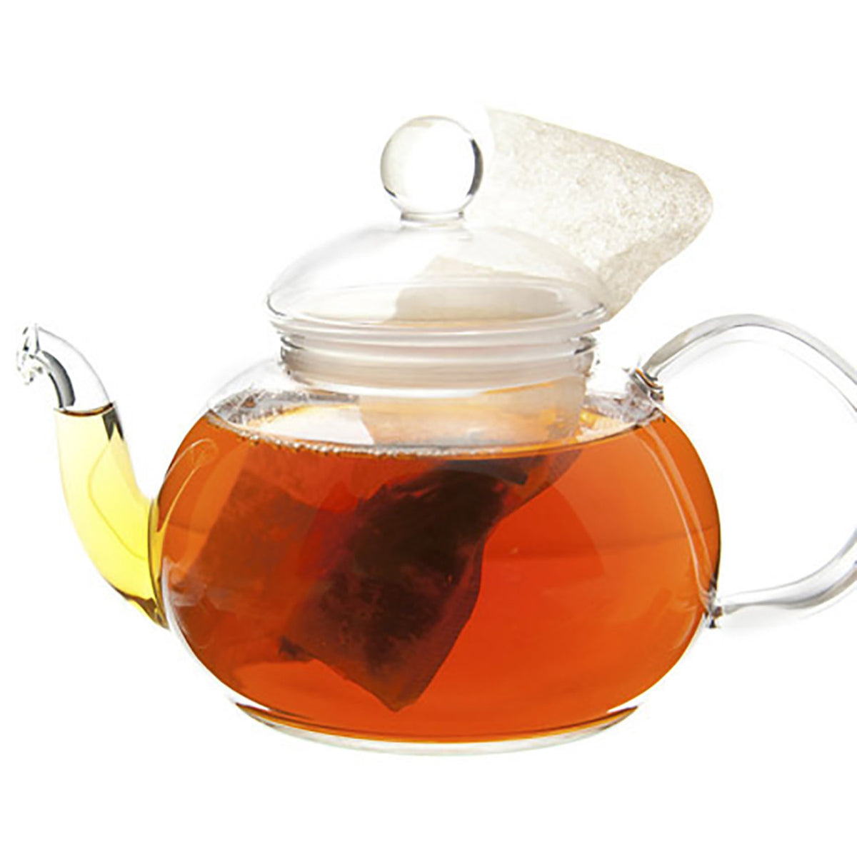 Clear glass teapot with a lid filled with tea on a white background