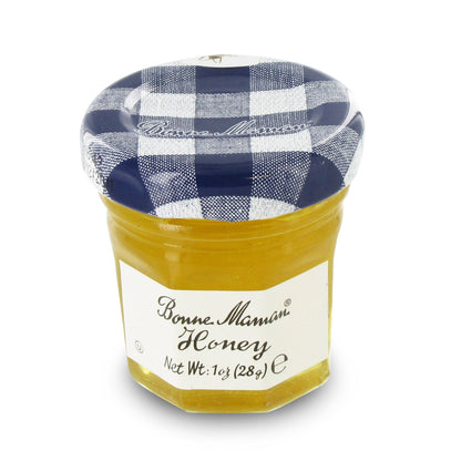 Jar of Bonne Maman Honey with a checkered lid on a white background