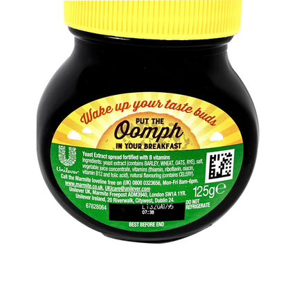 Back side of Marmite Yeast extract jar with yellow lid and label on a white background
