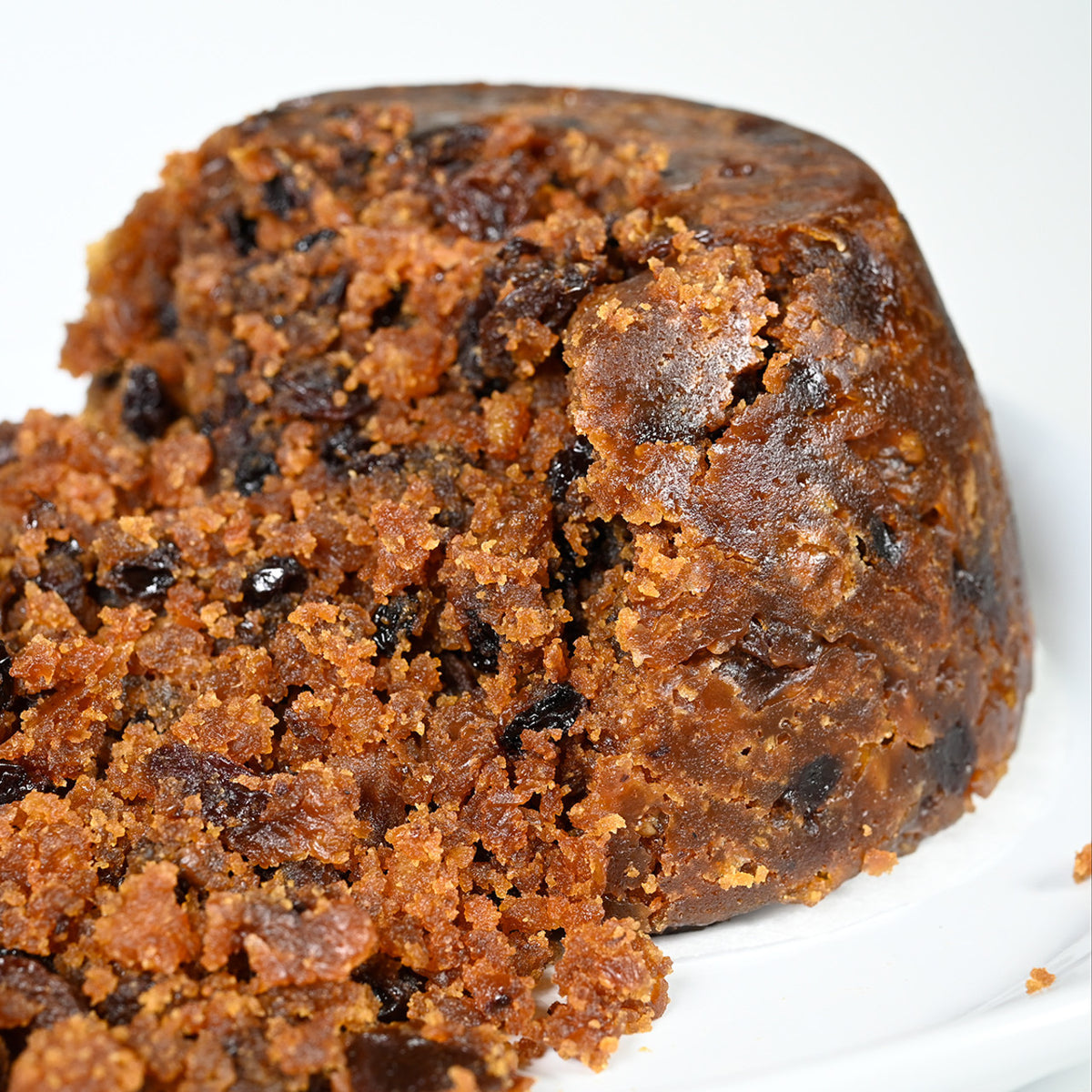 A close up of an unwrapped Cole's English Privilege Christmas Pudding.