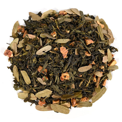 Tea blend with green leaves and dried flowers on a white background
