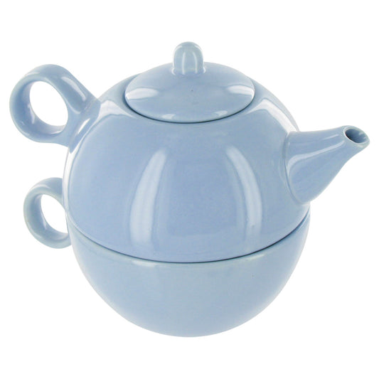 Light blue ceramic teapot stacked on a matching teamug on a white background