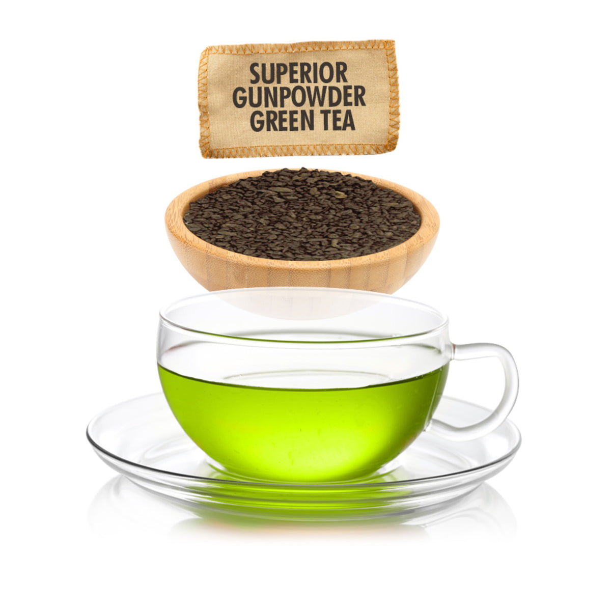 Clear glass cup of green tea with a wooden bowl of gunpowder green tea leaves and a label above on a white background.
