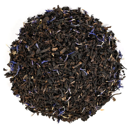Black tea with blue flower petals on a white background
