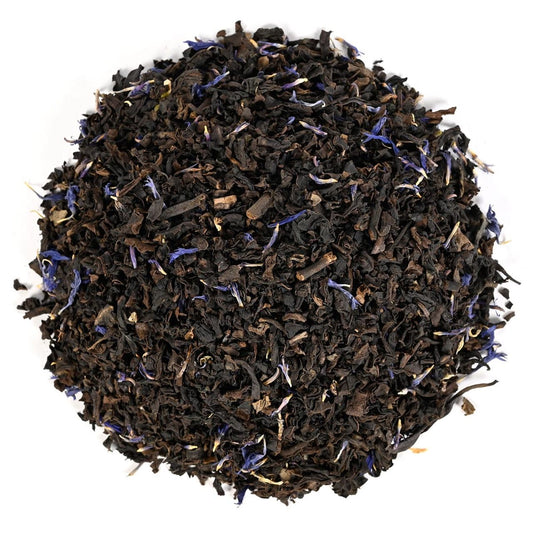 Black tea with blue flower petals on a white background