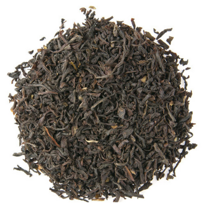 Circle pattern of dry English Breakfast tea leaves on a white background.
