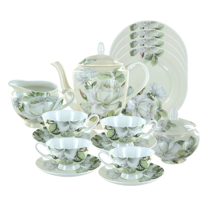 A bone china tea set with a white floral design on a cream background, including a teapot, cups with saucers, a sugar bowl with a lid, and a creamer. Dessert plates are also visible.