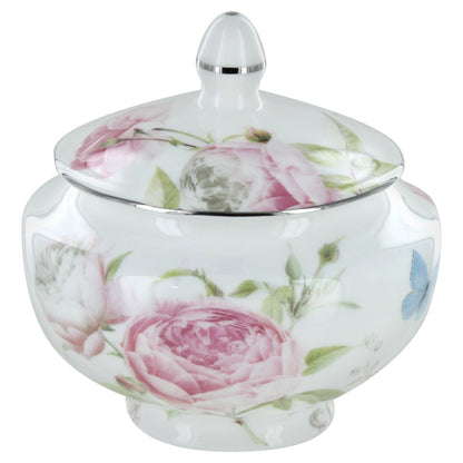 Rose bone ceramic sugar bowl with floral design and silver lid on a white background