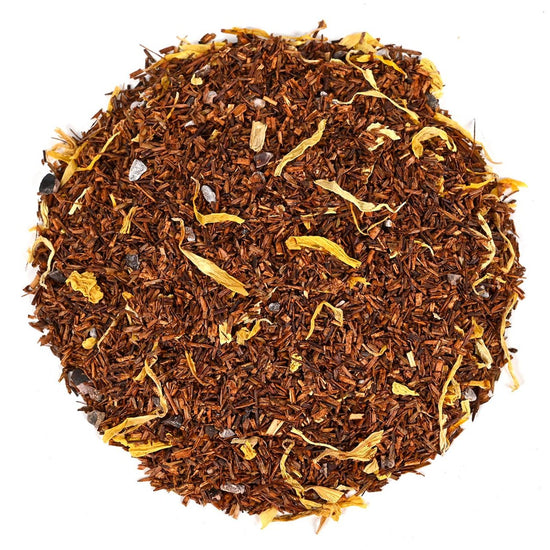 Round shape of rooibos tea with visible yellow petals on a white background.