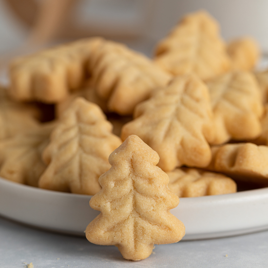 Close up of a plate of tree shaped short bread cookies