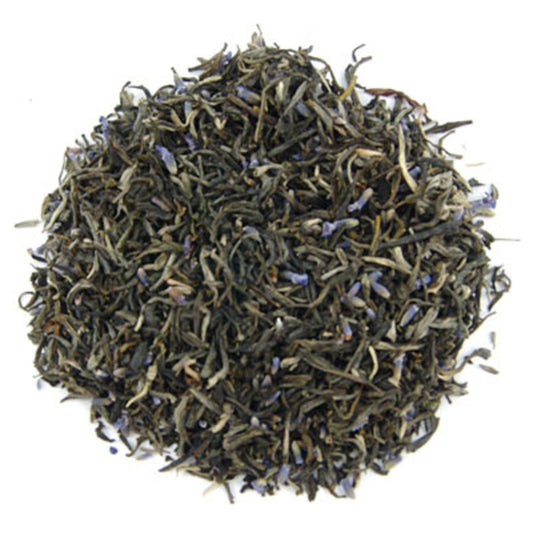 A pile of loose leaf green tea mixed with dried lavender petals.