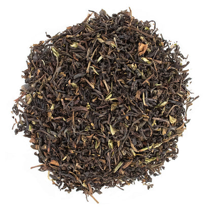 A close-up image of Margaret's Hope Darjeeling loose leaf tea, showing the dry leaves and buds.