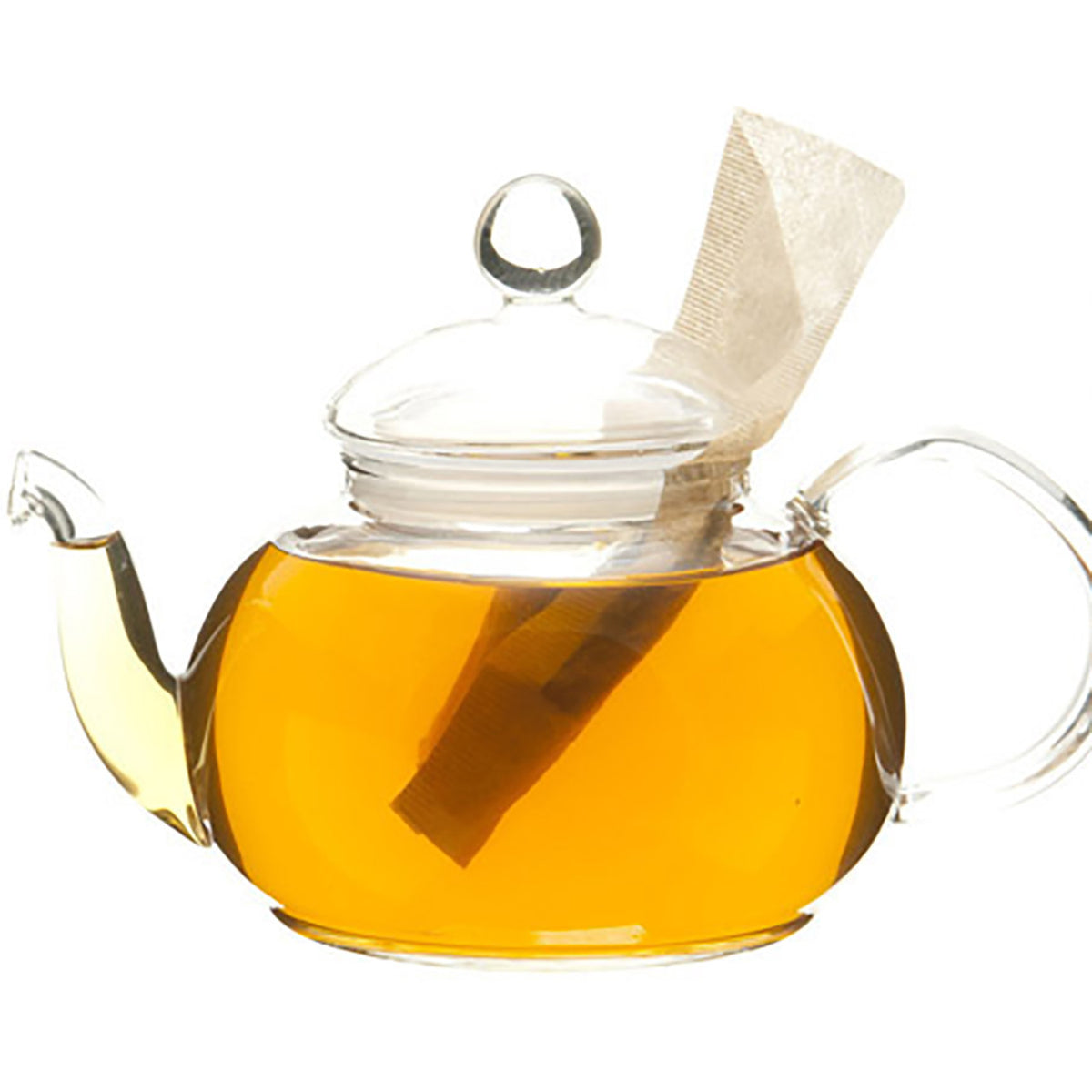 Glass teapot with peach colored tea and a teabag