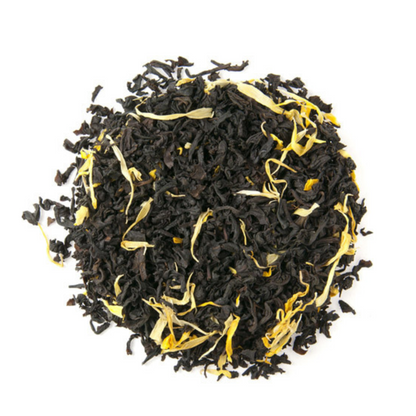 Black tea leaves with yellow strands on a white background